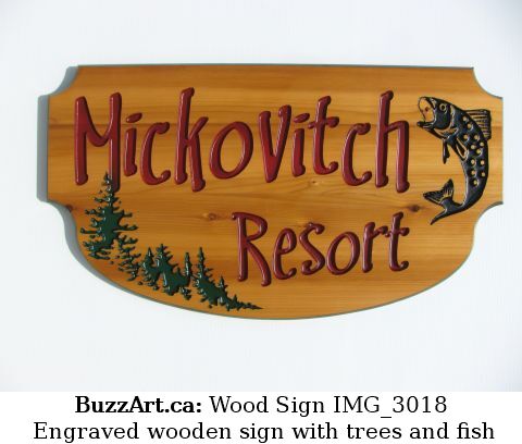 Engraved wooden sign with trees and fish